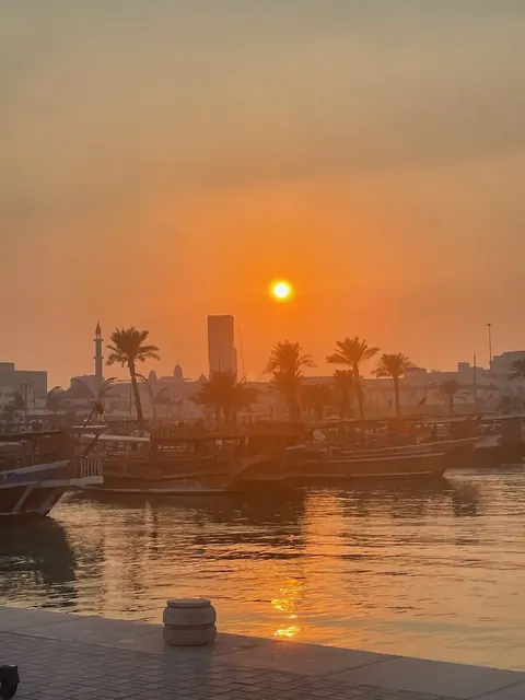 Sunset over dhows in harbour, Doha, our trip 2024 and 2025
